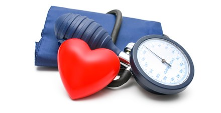 A heart next to a blood pressure cuff.