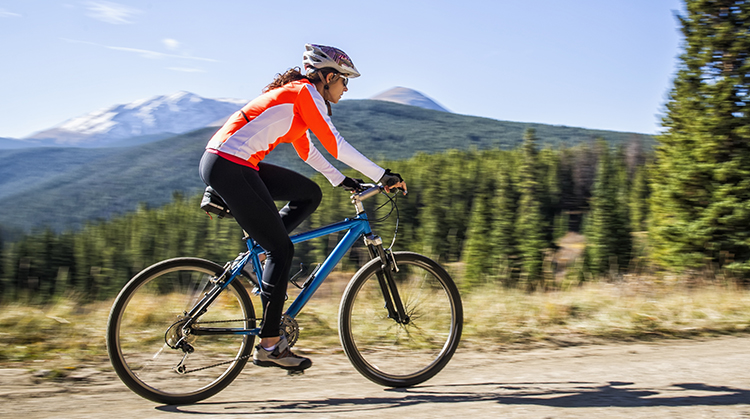 Woman cycling outside.