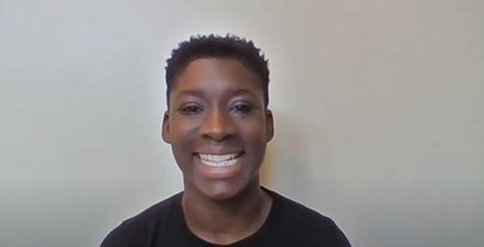 A physical therapist smiles, explaining exercises on video