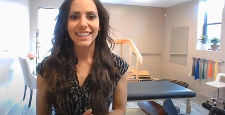 A physical therapist on video, explaining exercises for upper back and neck strain from office work.