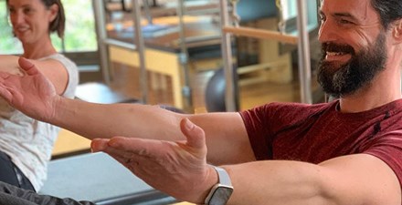 Ryan Hodgkinson and his sister Heidi Kosakowski doing pilates.