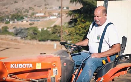 A rancher on his tractor.
