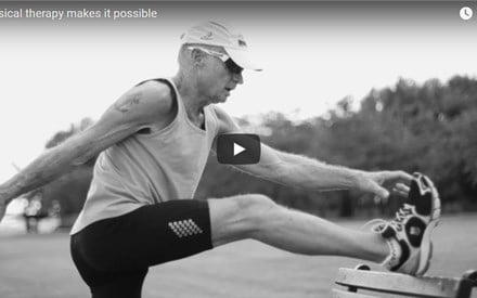 An older adult man stretching before a run.