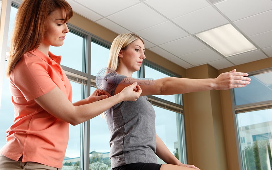 A physical therapist measures shoulder range of motion