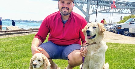Ted DeChane, PT, DPT, outside with his dogs.