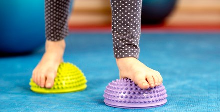A child walking on textured half rounds.