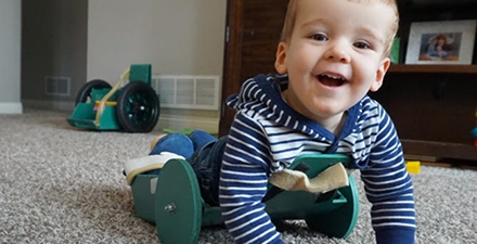 Brody, crawling on the ground, able to be mobile.