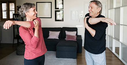 A couple exercising in their living room