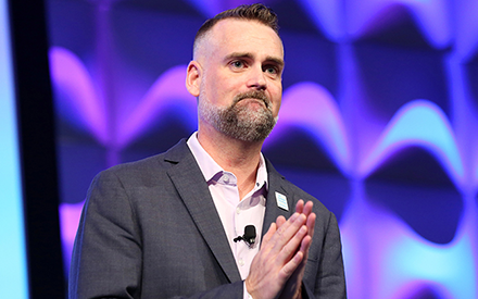 Justin Minyard on stage speaking to APTA members.