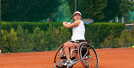 Person in a wheelchair playing tennis