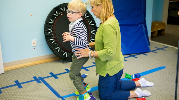 Spina Bifida A physical therapist working with a child.